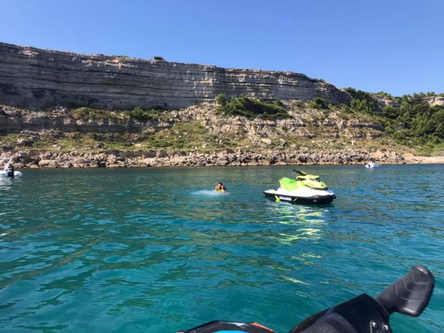 Photo de jet ski au large de Leucate, en fond la falaise et des personnes qui se baignent